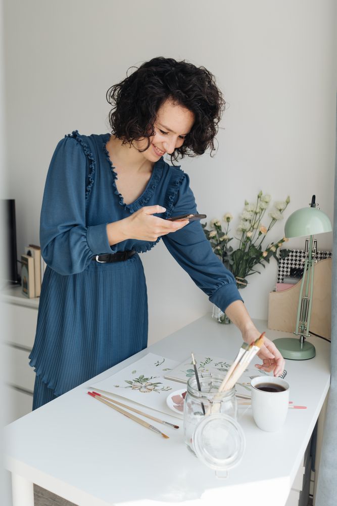 Artist photographing drawings with smartphone