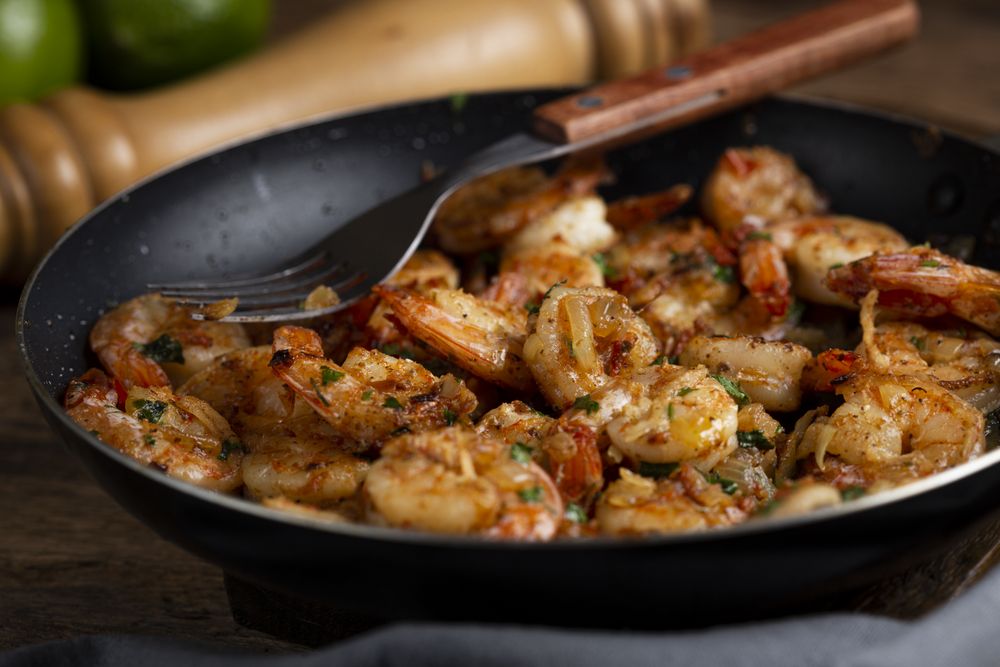 Delicious grilled prawns on wooden background.