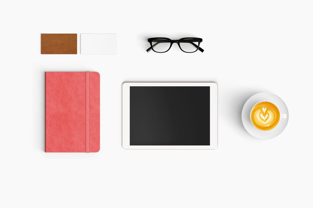 Modern workspace with coffee cup, notebook and tablet copy space