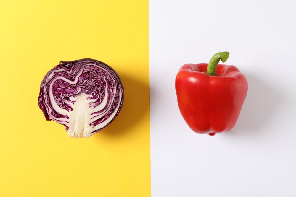 Cabbage and pepper on two tone background, space for text