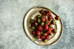 Strawberries scattered on ceramic plates