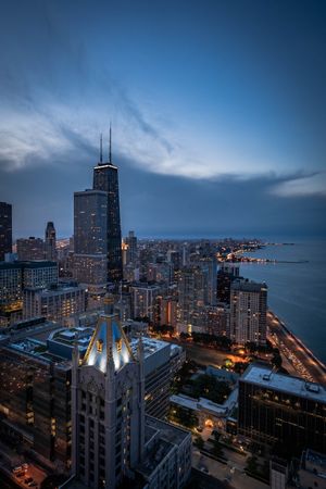 Aerial view of city by shoreline during night time