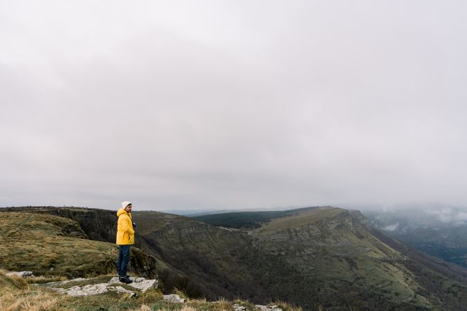 Man standing on top of hill