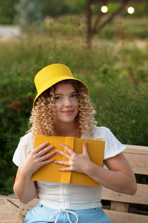 Woman with book outdoors