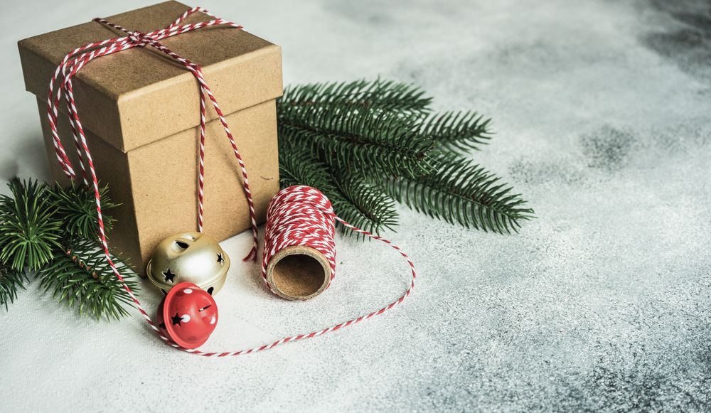 Christmas gift on counter with red string and ornaments