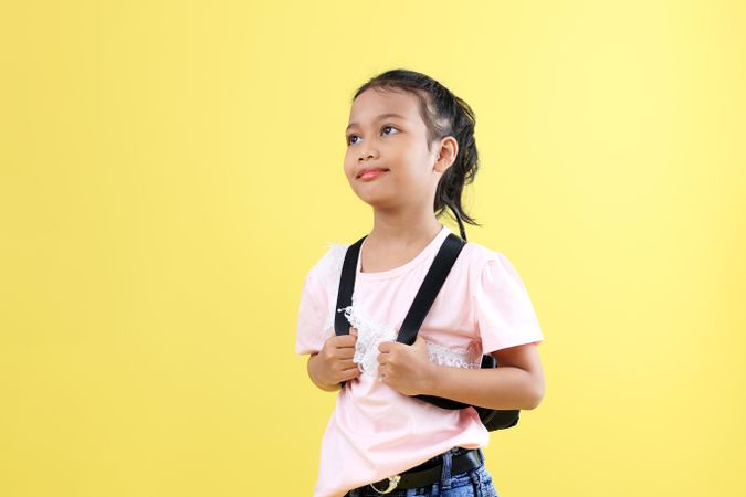 Young Asian Indonesia Kids with Pigtails Wearing Backpack, Look at the Top.