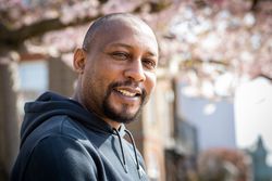 Portrait of smiling mature Black male with cherry blossoms