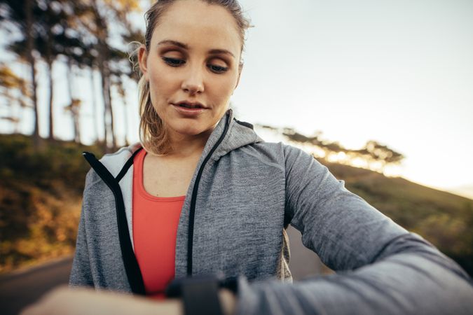Portrait of a fitness woman looking at her watch