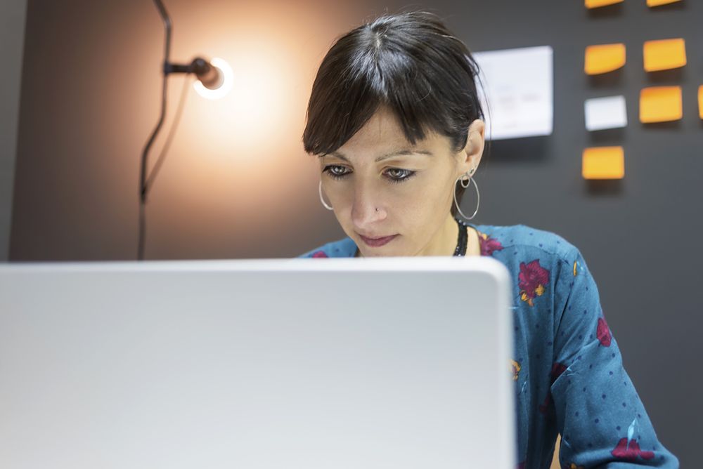Smiling businesswoman working with laptop