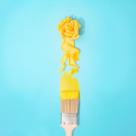 Paint brush with yellow rose flower and petals
