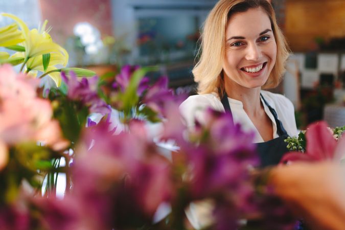 Happy female in flower shop