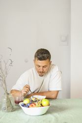 Casual Morning Routine: Adult Male Eating Muesli in Modern Dinning Room.