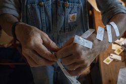 Woman farmer entrepreneur prepare price tags on her merchandise to sell
