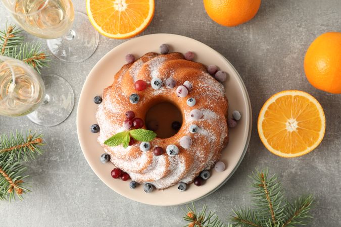 Cake with powder sugar and berries on grey table. Happy new year concept