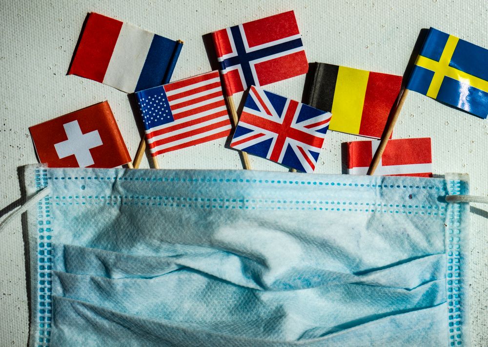 COVID-19 concept  with face mask and flags of countries