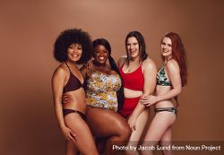 Diverse models in swimwear looking at camera and smiling 0LMzy5