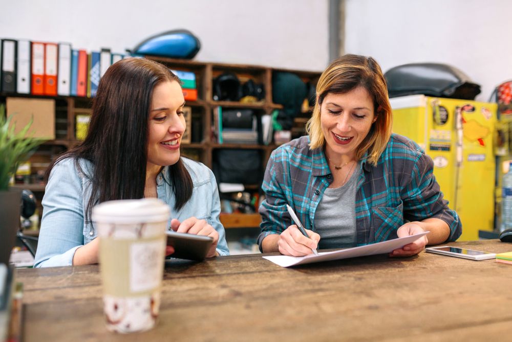 Cheerful females entrepreneur working in a small business to sell through online ecommerce
