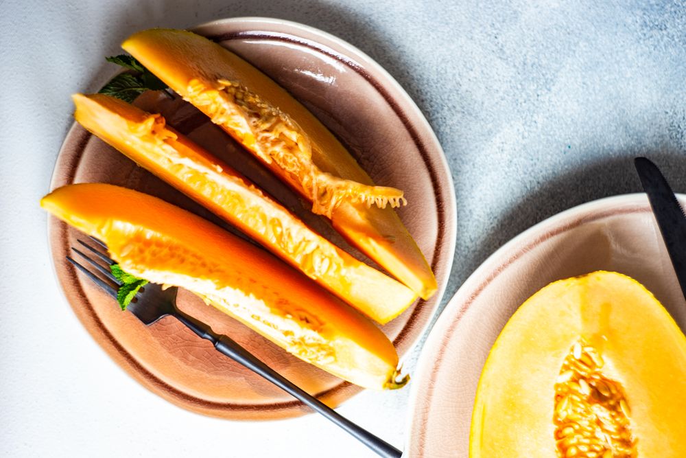 Slices of orange melon with fork