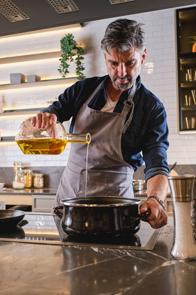 Man pouring oil into pot