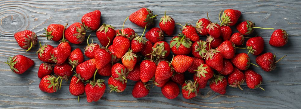 Tasty strawberry on wooden background, top view. Summer berry