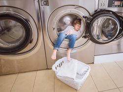 Boy sleeping in washing machine