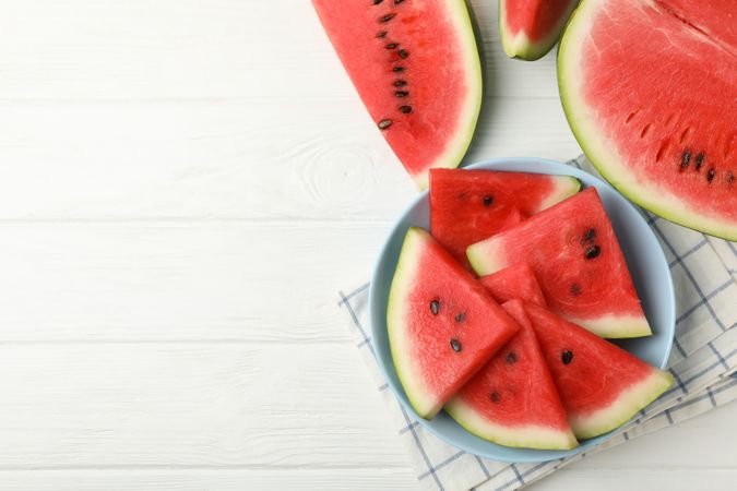 Composition with plate of fresh watermelon on wooden background, top view