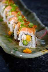 Delicious sushi rolls on traditional marble plate