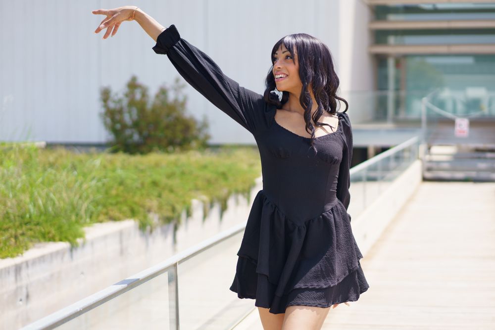 Woman dancing outside on sunny day