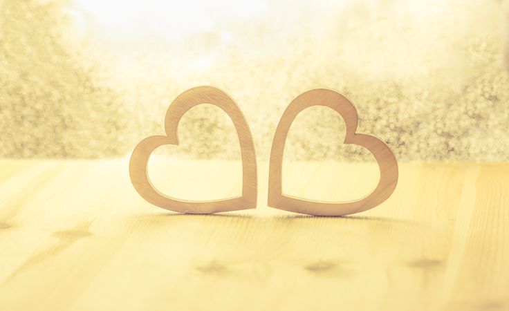 Wooden hearts on a shiny background