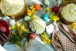Top view of Easter food concept with iced cakes, Easter eggs and spring flowers