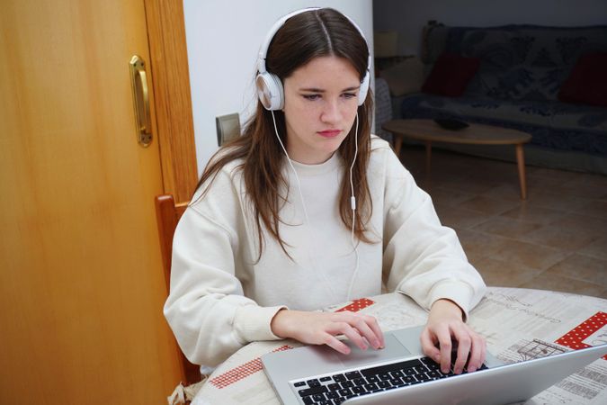 Teenage girl studying online at home