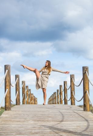 Young woman posing on footbridge