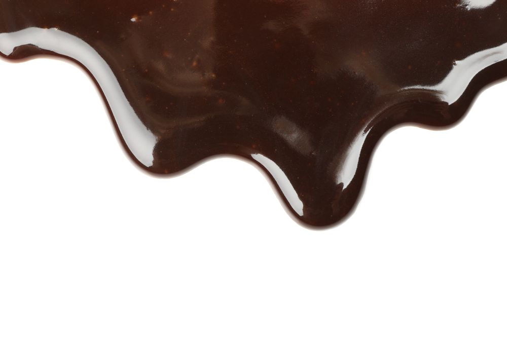Tasty melted chocolate isolated on blank background