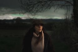 Young woman in warm clothes in forest