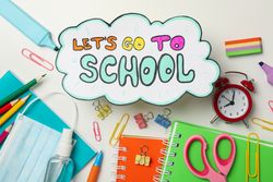 Text Let's go to school, school supplies, medical mask and sanitizer on blank background