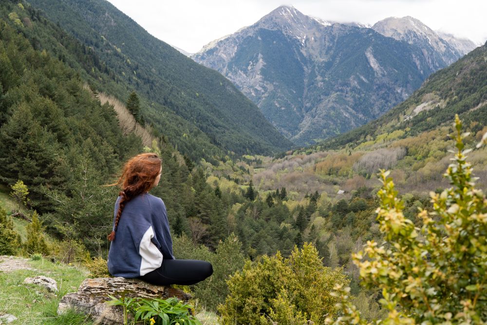 Unrecognizable traveler admiring view of rocky mountains