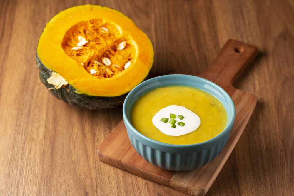 Bowl with pumpkin soup on the table.