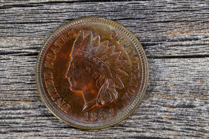 Uncirculated cent with profile of Native American face on condition on aged wood