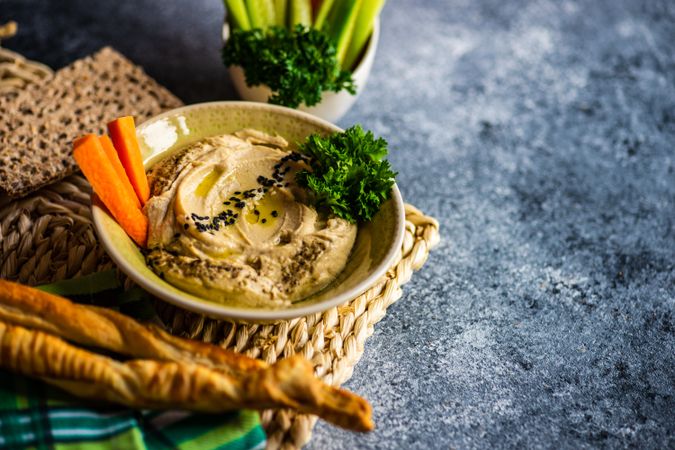 Creamy hummus on grey kitchen counter with copy space