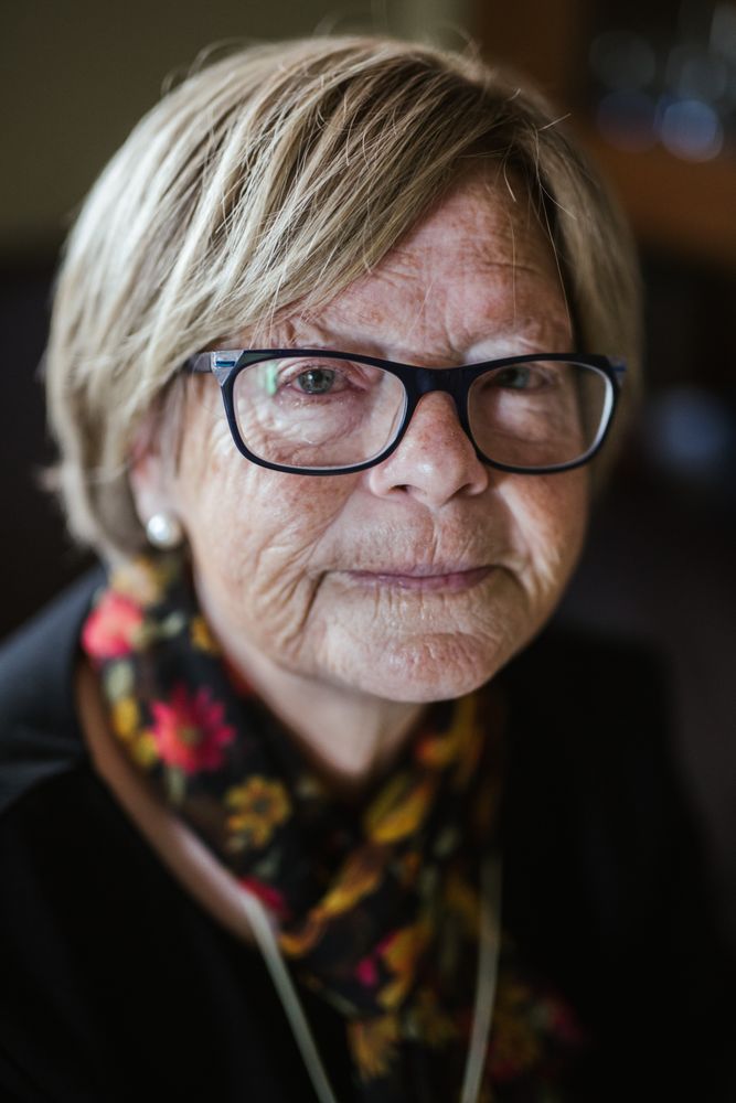 Older woman in glasses looking at camera