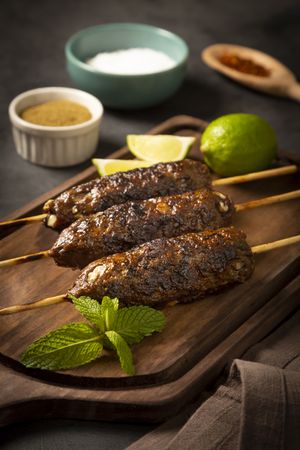 Beef kafta on the wooden board. Kafta, Traditional Arabic cuisine.