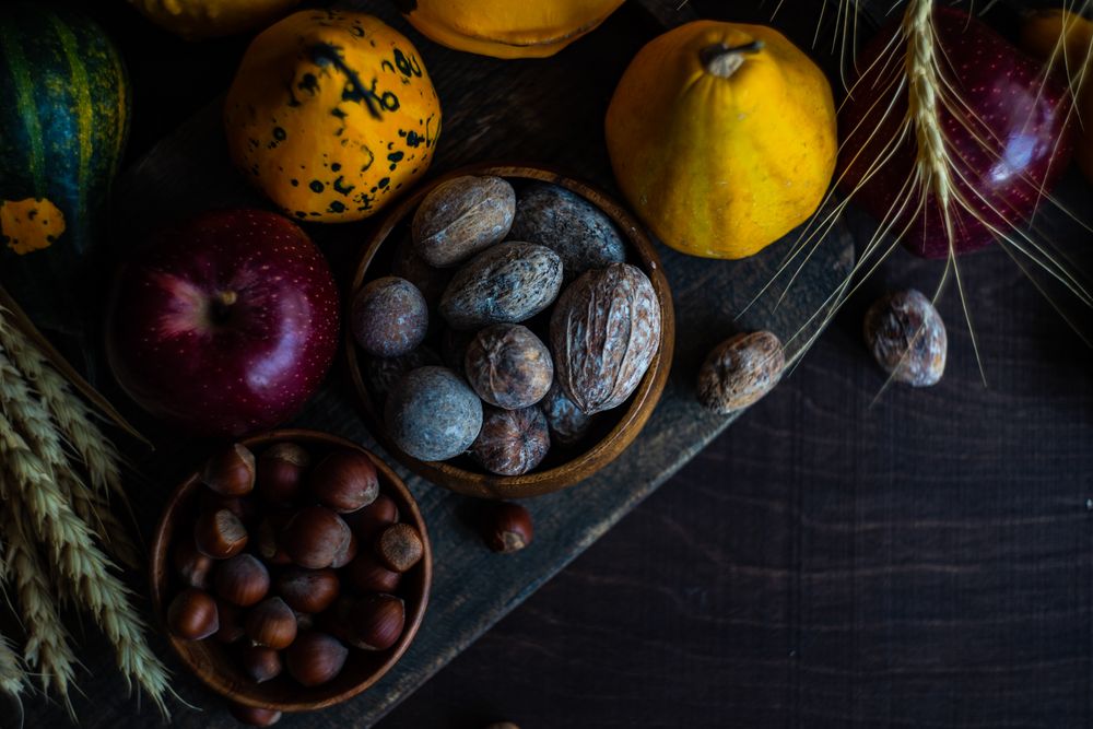 Top view of autumnal foods, nuts, squash and apples on wooden table