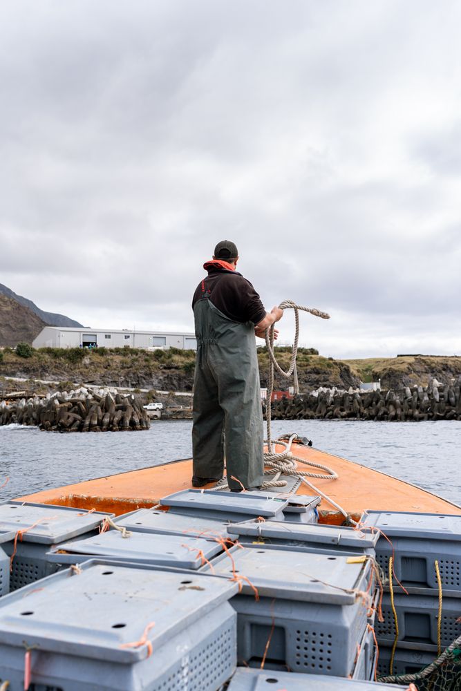 Fisherman on a lobster fishing boat mooring the boat