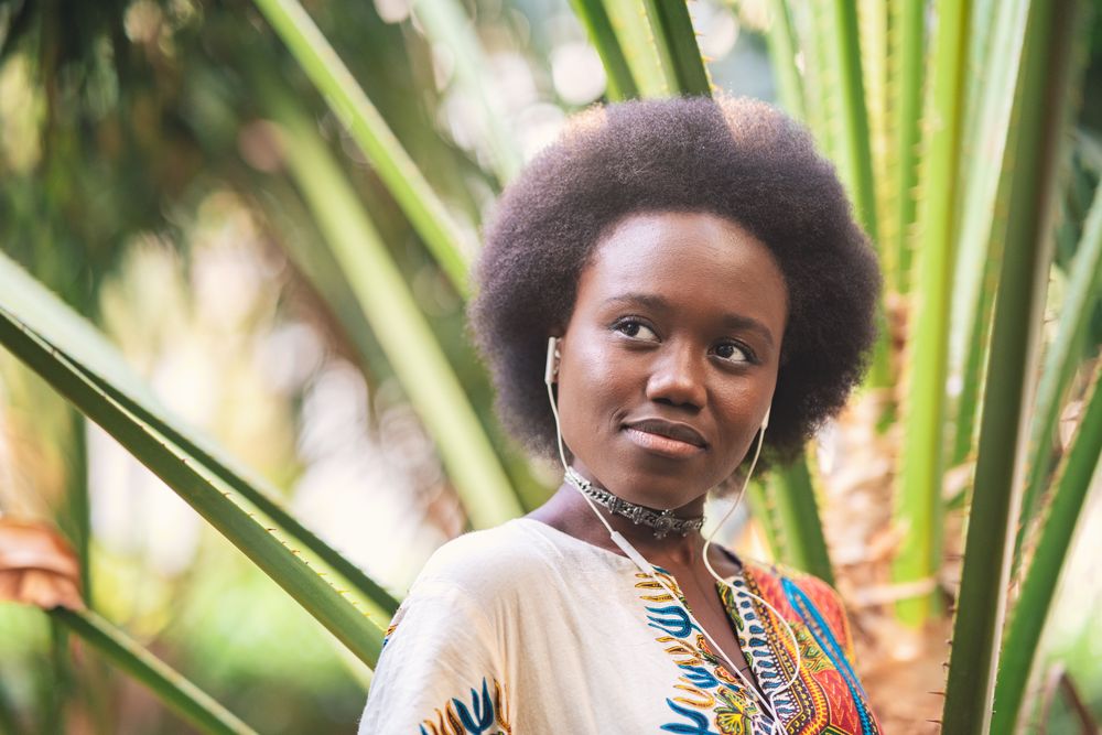 Smiling Black woman listening to music