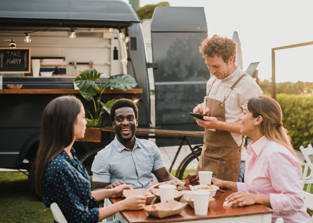 Multiracial people ordering food at food truck outdoor