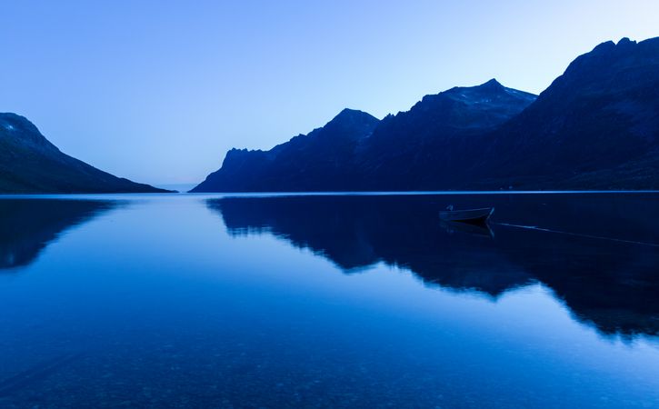 Lake near mountains under blue sky