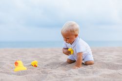 Baby boy playing with rubber ducks