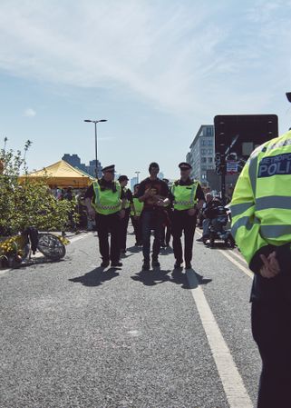 London, England, United Kingdom - April 19th, 2019: Police walk with protestor