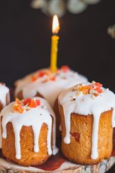 Close-up of little Easter cakes with candle lit on top