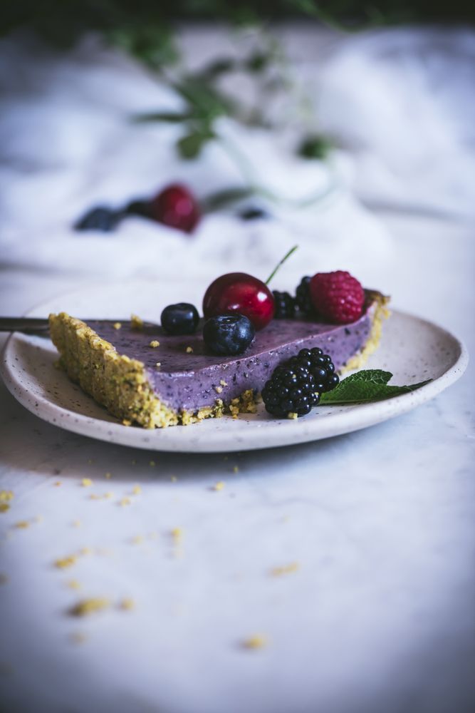 Blueberry pistachio sliced cake with whole berries on top